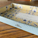Onlewo 'Orchid Rhapsody' leather valet tray in use — elegant desk or bedside organiser with Singapore orchid design