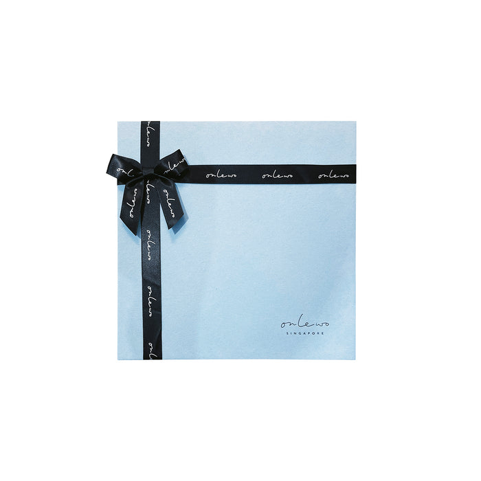 Onlewo 'Peranakan Story' bone china plate gift box — powder blue velvet square box tied with black Onlewo branded satin ribbon, ready for gifting